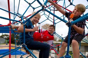 three boys playing on the playground at BIG4 Mornington Peninsula Holiday Park in Frankston