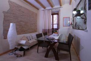 a living room with a table and a couch at Casa Stampaxi in Cagliari