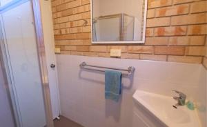 a bathroom with a sink and a mirror at Esperance Beachfront Resort in Esperance