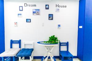a room with blue chairs and a table and a house at Long house in Taichung