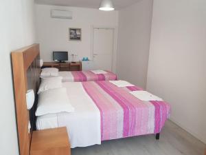 Postel nebo postele na pokoji v ubytování Duna camere con bagno