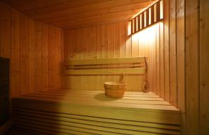 a wooden sauna with a wooden bucket in it at Sun Seasons 24 - Domek Bacówka in Wisła