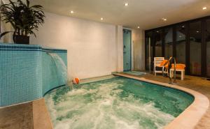 a indoor swimming pool with a water fountain at Hotel Antares in Cattolica