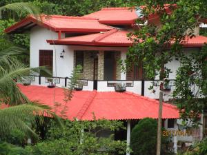a house with a red roof at Maneesha Guest House in Weligama