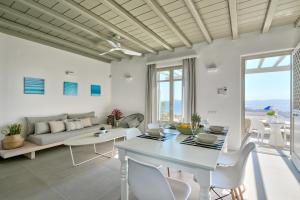 a living room with a table and a couch at Tourlos Bay Villas Mykonos in Tourlos
