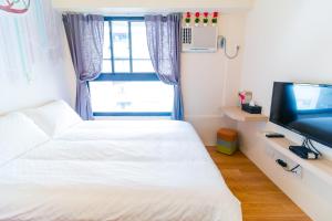 Ένα ή περισσότερα κρεβάτια σε δωμάτιο στο Taichung FJ Victoria