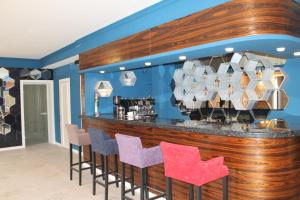 a bar with purple and pink chairs in a room at Non-stop Economy hotel in Boryspil