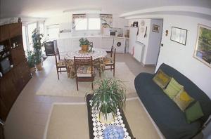 a kitchen and living room with a table and a couch at L'Hernani in Capbreton