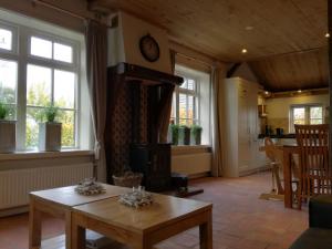 a living room with a table and a stove at Vakantiehuis Ganderhoeve in Gaanderen