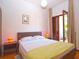 a bedroom with a large bed and a window at Rooms Ivica 1452 in Fažana