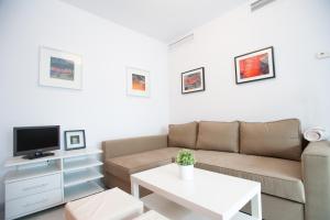 a living room with a couch and a table at Apartamento San Bernardo in Seville