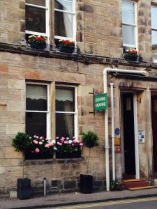 a building with flower boxes and a sign on it at Doune Guest House in St Andrews