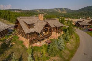 an overhead view of a log house with a road at Spanish Peaks Settlement Cabin in Big Sky
