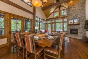 a dining room with a table and a fireplace at Homestead Cabin 2 in Big Sky