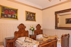 a bedroom with two beds and a mirror at Metropolitan Apartments in Krakow