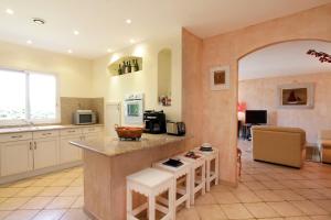 a kitchen with a counter and a table in a room at Villas les Residences de Scaglione in Porticcio
