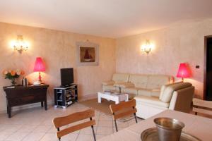 een woonkamer met een bank en een tv bij Villas les Residences de Scaglione in Porticcio