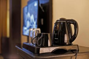 a black coffee pot sitting on a table at United Business Hotel in Kathmandu
