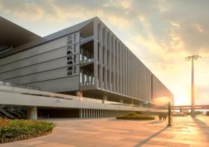 a large building with people standing outside of it at Sanya Phoenix Airport Hotel in Sanya