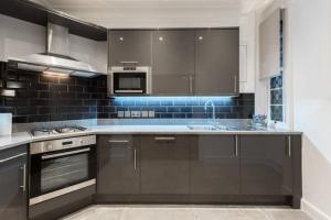a kitchen with a sink and a stove top oven at Fleet Street Apartment 3 in London