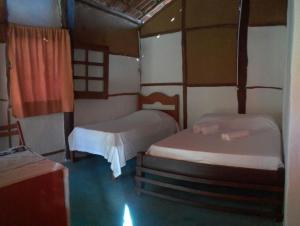 Giường trong phòng chung tại Pousada Aldeia de Morere