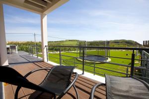 a balcony with chairs and a grill and a view at Villa Mastlo in Assenta