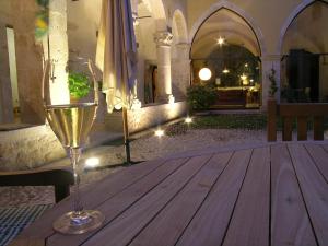 a glass of wine sitting on a wooden table at Grancia dei Celestini in Sulmona