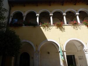 a building with a balcony with flowers on it at Grancia dei Celestini in Sulmona