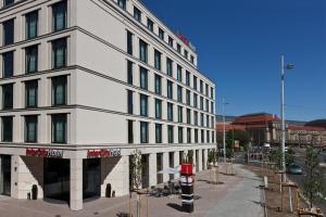 a large white building on a city street at IntercityHotel Leipzig in Leipzig