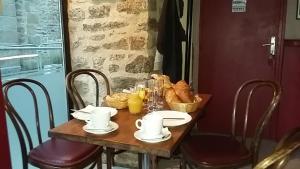a table topped with plates and bowls of food at Cafe Hotel du Theatre in Dinan