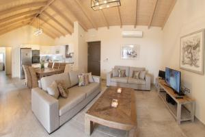 a living room with a couch and a table at Euphoria Retreat in Mánganos