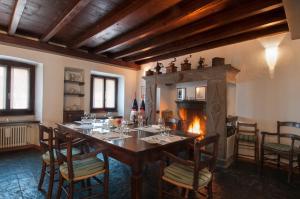 a dining room with a table and a fireplace at Vecchia Osteria Seseglio in Chiasso