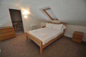 a small bedroom with a bed in a attic at Princes Dock Chambers 10 in Hull