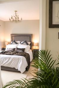 a bedroom with a bed with white sheets and pillows at Carlingford Sea Cottage in Carlingford