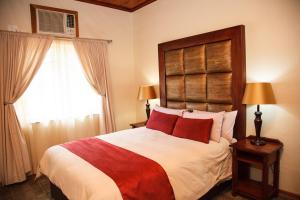 a bedroom with a large bed and a window at Blyde Canyon, A Forever Resort in Matibidi