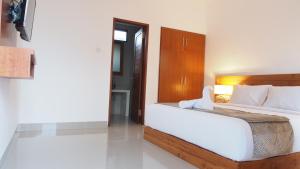 Postel nebo postele na pokoji v ubytování Kakol Homestay