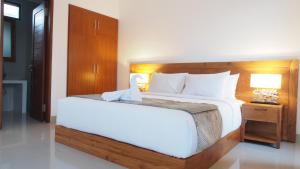 Postel nebo postele na pokoji v ubytování Kakol Homestay