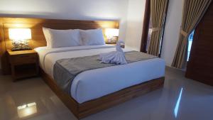Postel nebo postele na pokoji v ubytování Kakol Homestay