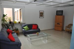 a living room with two couches and a coffee table at Eduard-Heinrich-Haus, Hostel in Salzburg