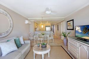 a living room with a couch and a table at Bougainvillea Barbados in Christ Church