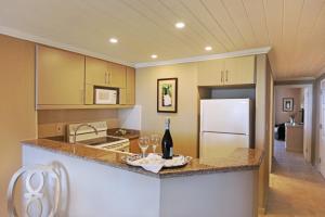 a kitchen with a counter with a bottle of wine at Bougainvillea Barbados in Christ Church