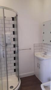 a bathroom with a shower and a sink at Stafford apartments in Stafford +115 photos