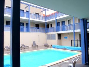 a large swimming pool in front of a building at Le 225 in Biscarrosse