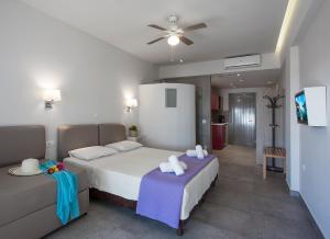 a bedroom with two beds and a couch at Locanda Barbati Luxury ApartHotel in Barbati