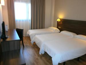 Postel nebo postele na pokoji v ubytování Hotel Pago del Olivo