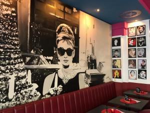 a mural of a woman with sunglasses on a wall at Hollywood Media Hotel am Kurfürstendamm in Berlin