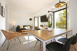 a living room with a dining table and chairs at Atocha Hub - Madflats Collection in Madrid