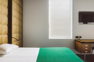 Un pat sau paturi într-o cameră la Hotel Pilar