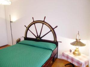 a bed in a room with a large wooden wheel on it at Villa Eleonora in Grado