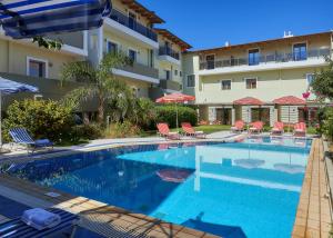 a swimming pool in front of a building at Panormo Beach Hotel in Panormos Rethymno